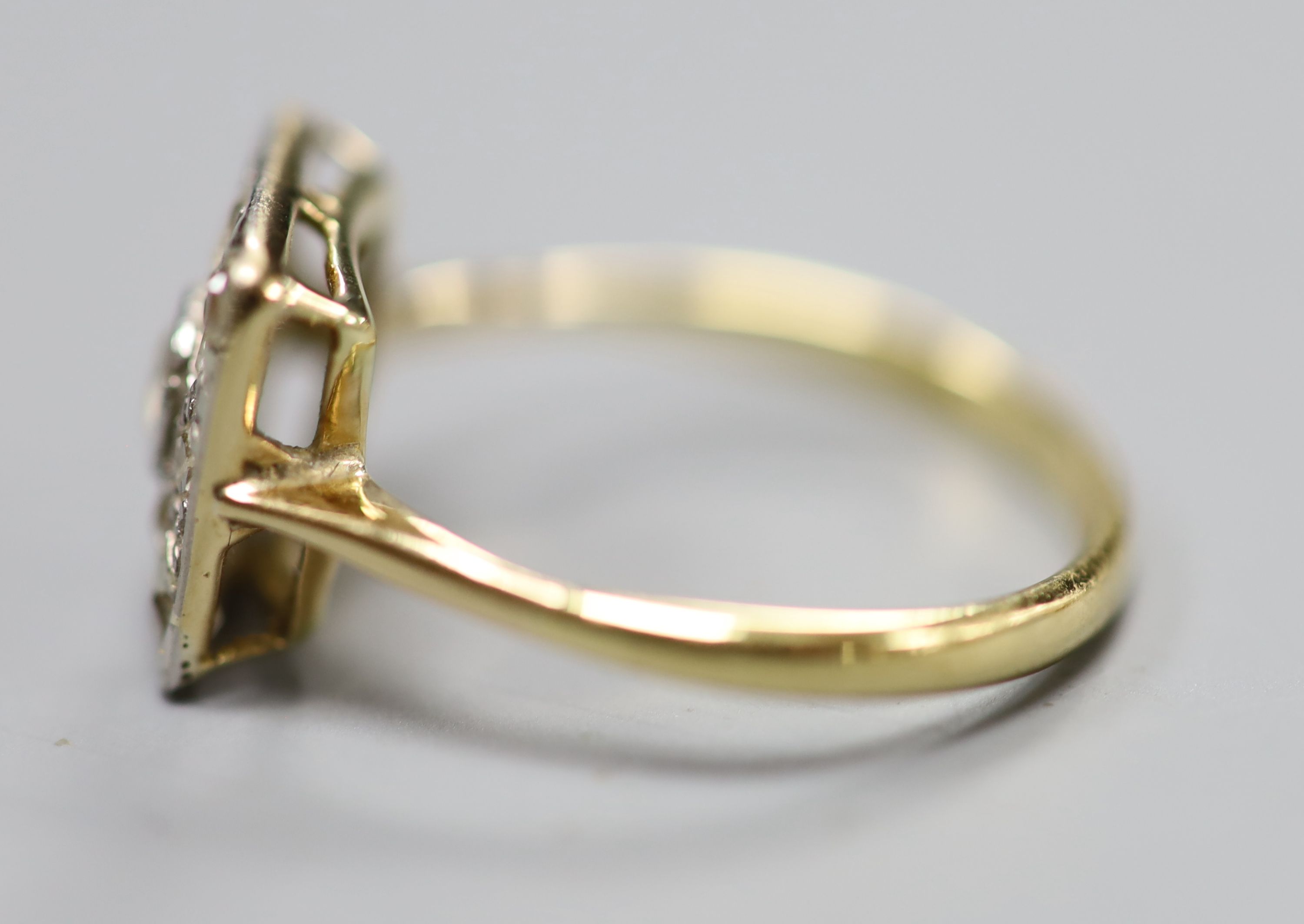 A 1940s yellow metal and diamond set square cluster ring, size M, gross 2.8 grams.